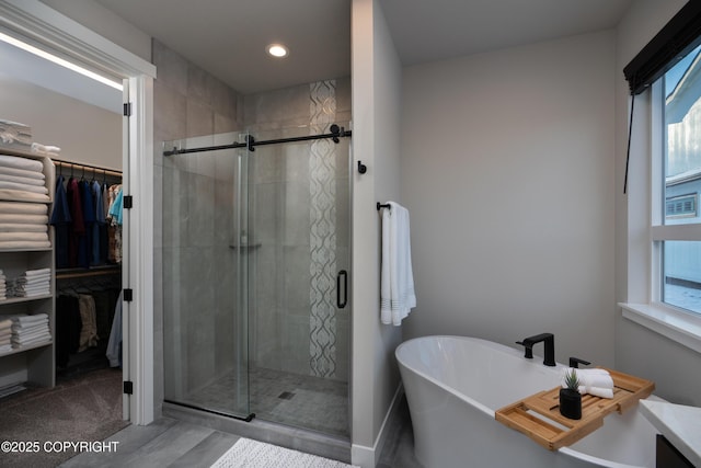 bathroom featuring shower with separate bathtub