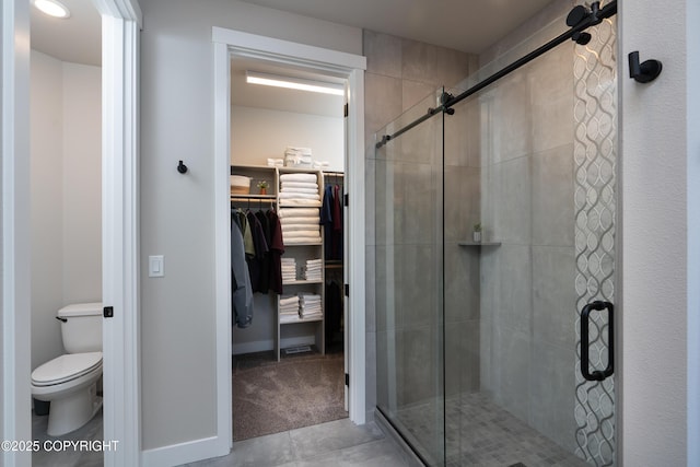 bathroom with toilet and an enclosed shower