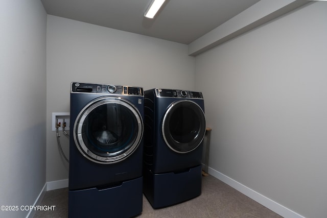 laundry room featuring independent washer and dryer and carpet flooring