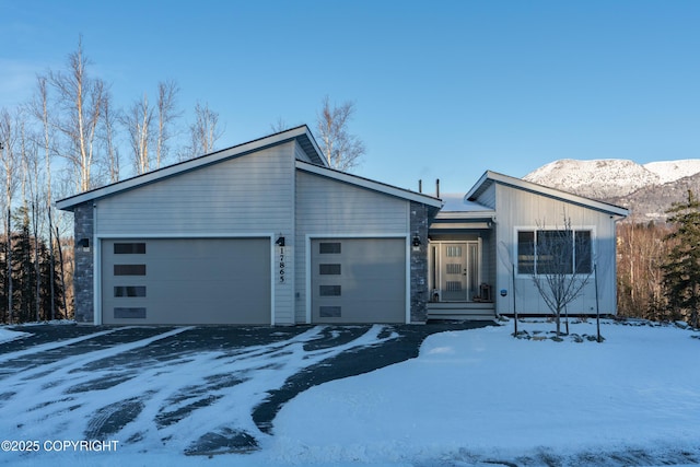 view of front of home featuring a garage and a mountain view