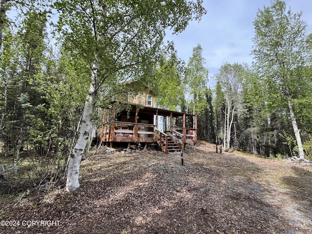 rear view of property featuring a wooden deck