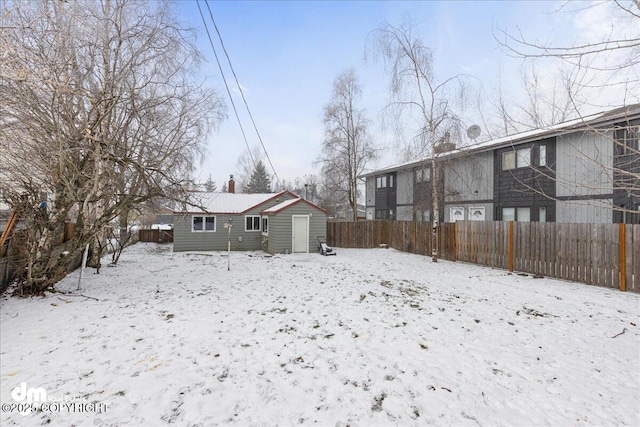 snow covered house with a shed