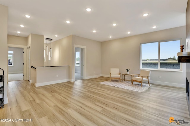 sitting room with light hardwood / wood-style floors and a wealth of natural light