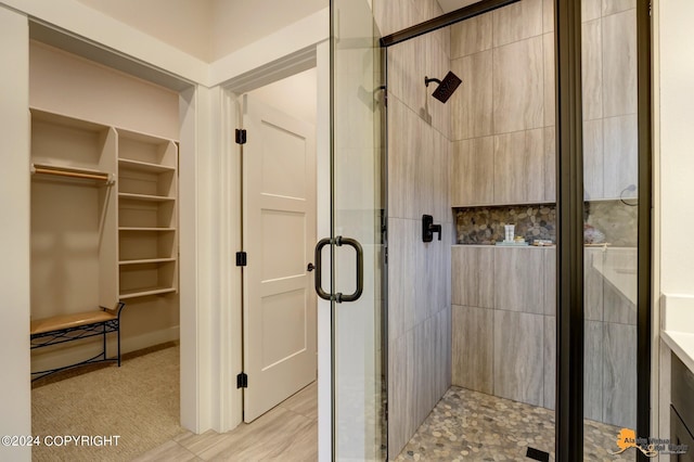 bathroom featuring a shower with shower door