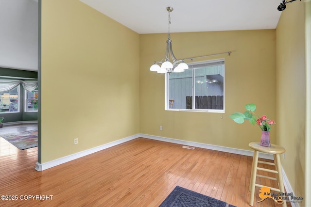 7541 Florence Cir, Anchorage, AK 99507 - spare room with wood-type flooring, baseboards, and a chandelier