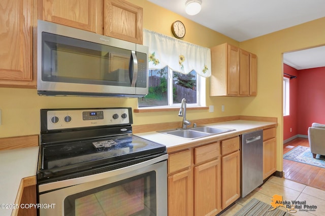 7541 Florence Cir, Anchorage, AK 99507 - kitchen with appliances with stainless steel finishes, a sink, light countertops, light tile patterned floors, and light brown cabinets