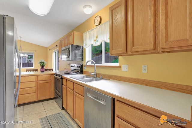 7541 Florence Cir, Anchorage, AK 99507 - kitchen with appliances with stainless steel finishes, a sink, vaulted ceiling, light countertops, and light tile patterned floors