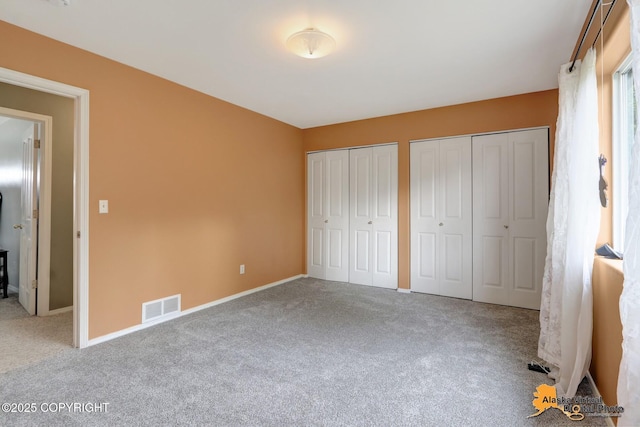 7541 Florence Cir, Anchorage, AK 99507 - unfurnished bedroom with carpet floors, two closets, and baseboards