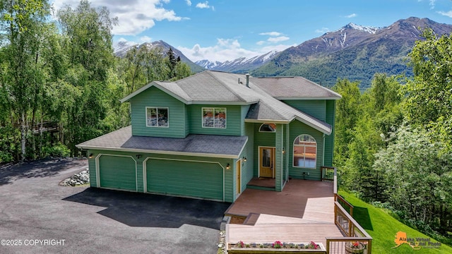 10235 Stewart Dr, Eagle River, AK 99577 - view of front of property featuring an attached garage, driveway, a mountain view, and a shingled roof