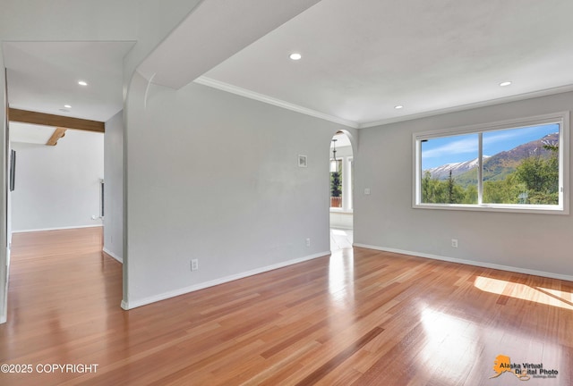 10235 Stewart Dr, Eagle River, AK 99577 - spare room featuring arched walkways, light wood finished floors, recessed lighting, and ornamental molding