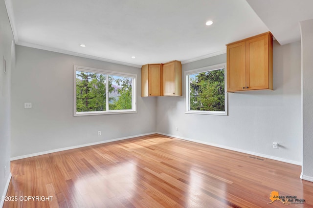 10235 Stewart Dr, Eagle River, AK 99577 - empty room featuring healthy amount of natural light, light wood-style floors, crown molding, and recessed lighting