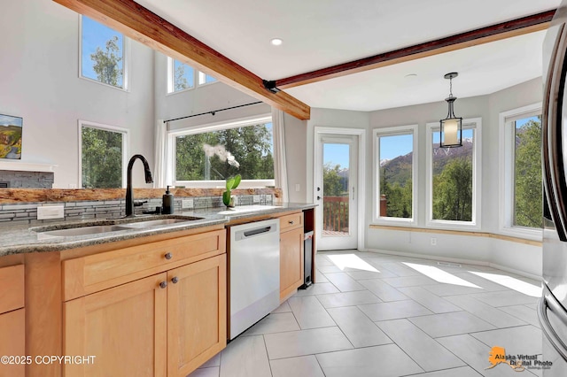 10235 Stewart Dr, Eagle River, AK 99577 - kitchen featuring dishwashing machine, light brown cabinetry, light stone countertops, pendant lighting, and light tile patterned floors
