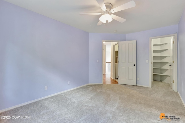 10235 Stewart Dr, Eagle River, AK 99577 - unfurnished bedroom with carpet, a spacious closet, a ceiling fan, and a closet