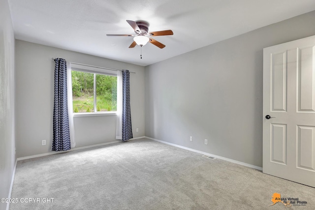 10235 Stewart Dr, Eagle River, AK 99577 - carpeted spare room with ceiling fan and baseboards
