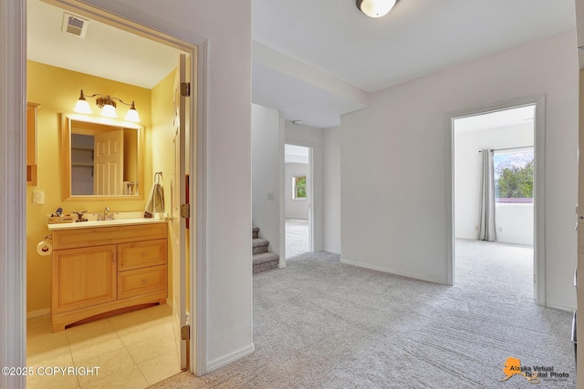 10235 Stewart Dr, Eagle River, AK 99577 - hall featuring healthy amount of natural light, stairway, and light colored carpet