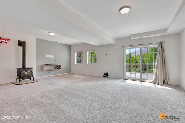 10235 Stewart Dr, Eagle River, AK 99577 - unfurnished living room featuring a wood stove and carpet
