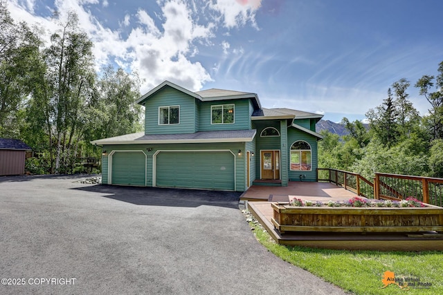 10235 Stewart Dr, Eagle River, AK 99577 - view of front of house featuring an attached garage and driveway