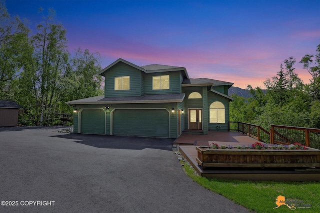 10235 Stewart Dr, Eagle River, AK 99577 - view of front of house with an attached garage and driveway