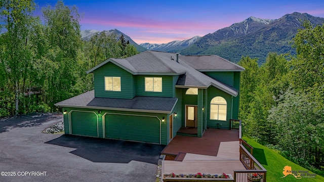 10235 Stewart Dr, Eagle River, AK 99577 - view of front of property with a mountain view, an attached garage, asphalt driveway, and a shingled roof