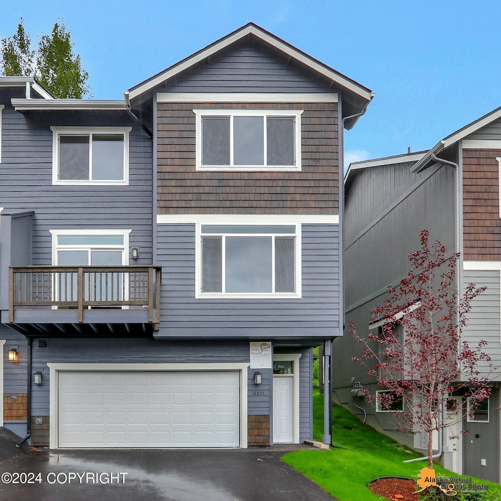 view of front of home with a balcony and a garage