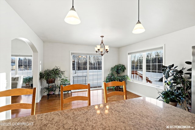 kitchen featuring an inviting chandelier, decorative light fixtures, and wood-type flooring