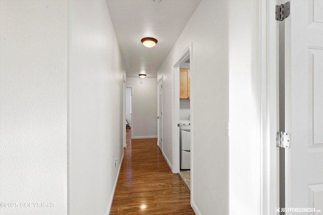 hallway with hardwood / wood-style flooring