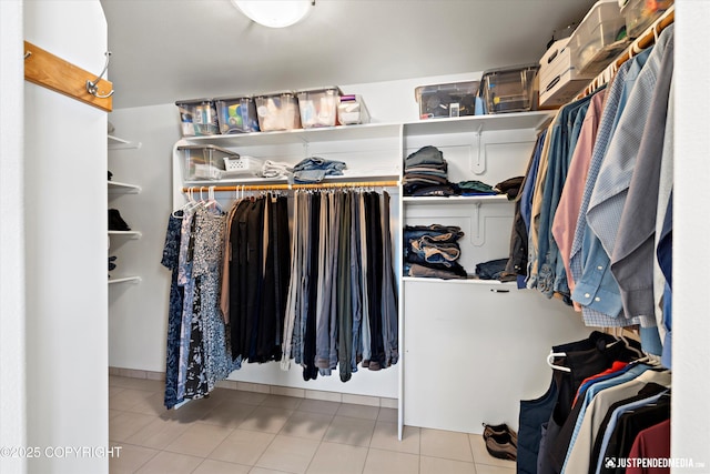 spacious closet featuring light tile patterned floors