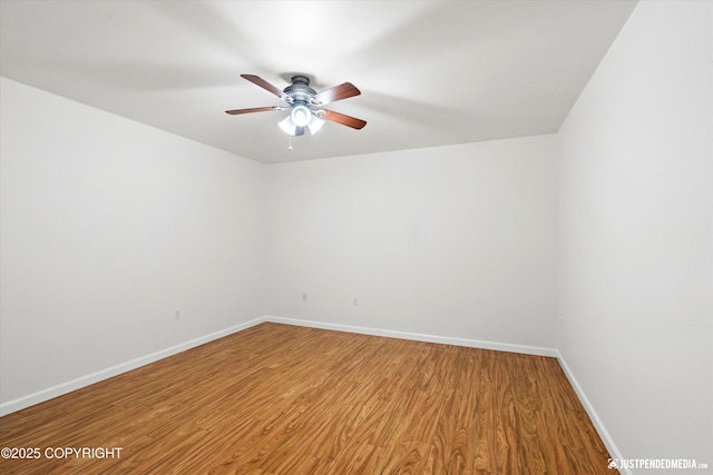 spare room with hardwood / wood-style floors and ceiling fan