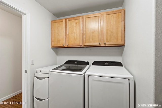 laundry room with cabinets, dark hardwood / wood-style floors, and separate washer and dryer