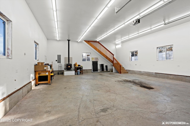 garage with a wood stove and electric panel