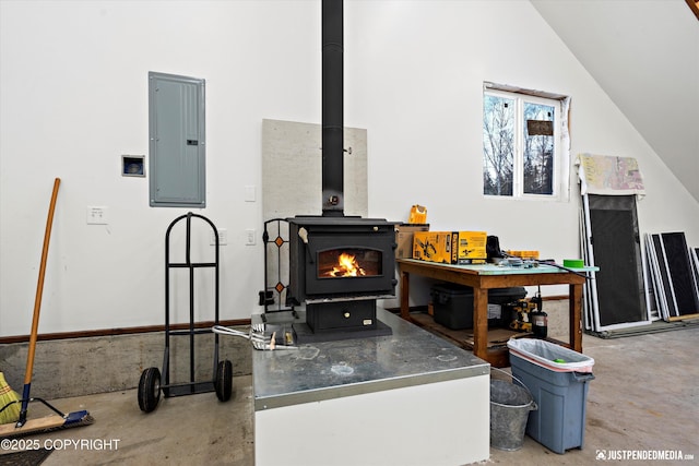 living room with lofted ceiling and electric panel