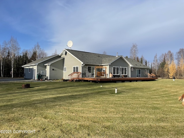 back of house featuring a wooden deck and a yard