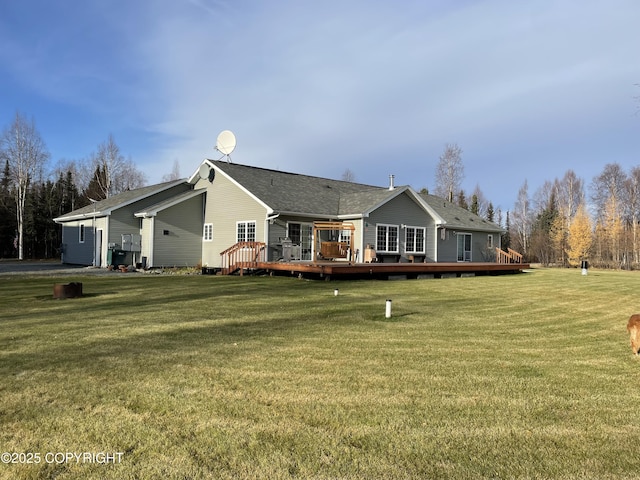 rear view of property with a deck and a lawn