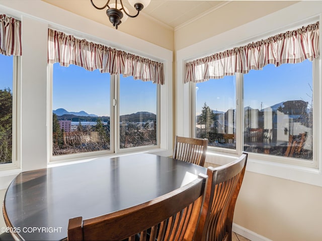 dining space with crown molding and a mountain view