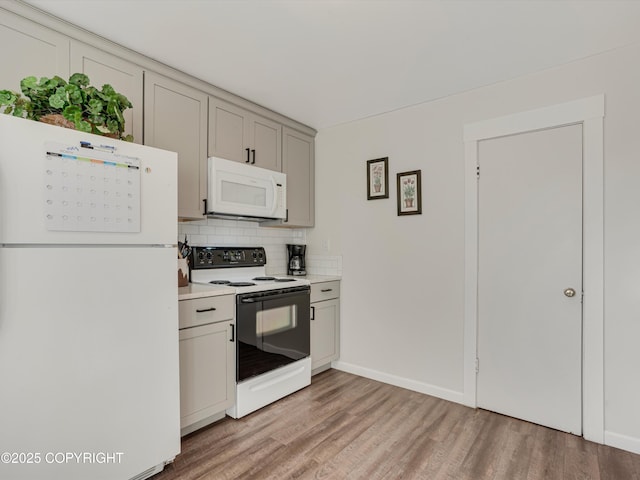 kitchen with white appliances, wood-type flooring, and backsplash