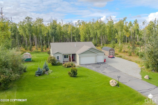 view of front of property featuring a garage, a storage unit, and a front yard