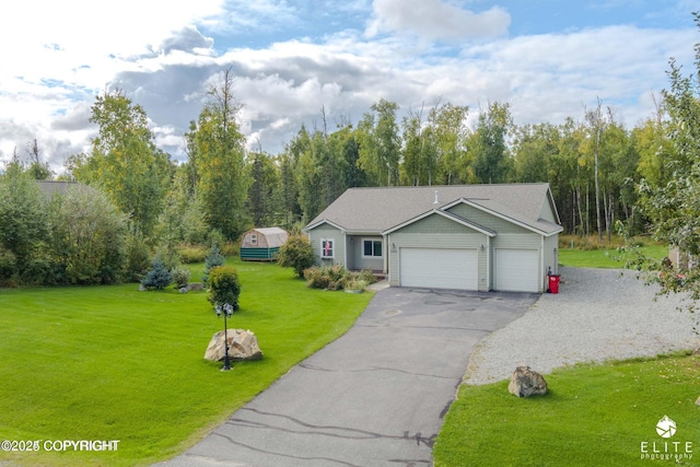 view of front of property featuring a garage and a front yard