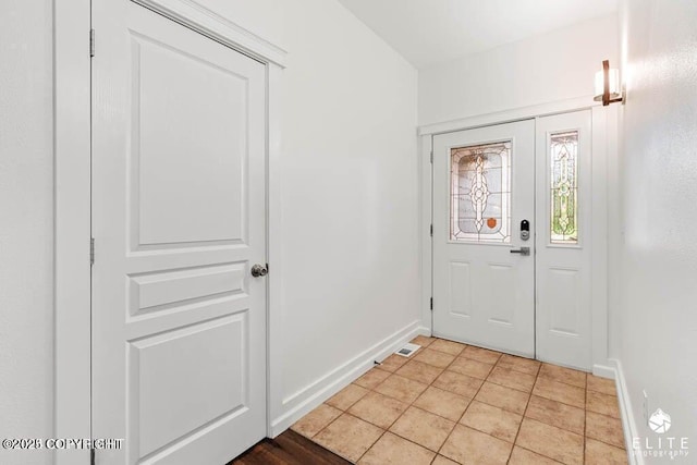 doorway featuring light tile patterned floors