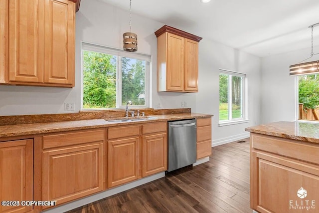 kitchen featuring a wealth of natural light, sink, stainless steel dishwasher, and decorative light fixtures