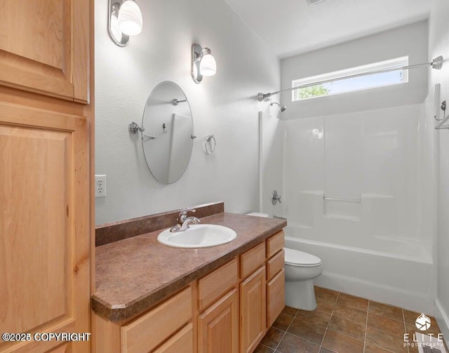 full bathroom featuring bathing tub / shower combination, vanity, tile patterned floors, and toilet