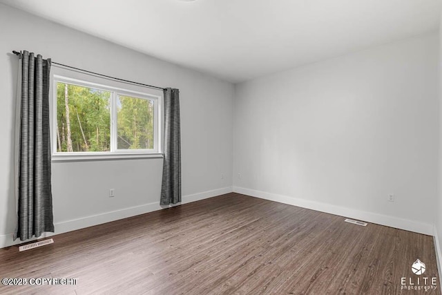 unfurnished room with hardwood / wood-style floors