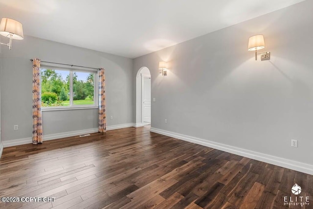 unfurnished room featuring dark hardwood / wood-style floors