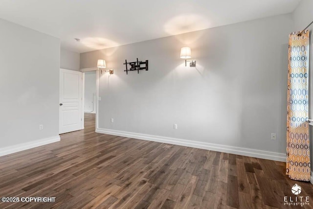 spare room with dark wood-type flooring