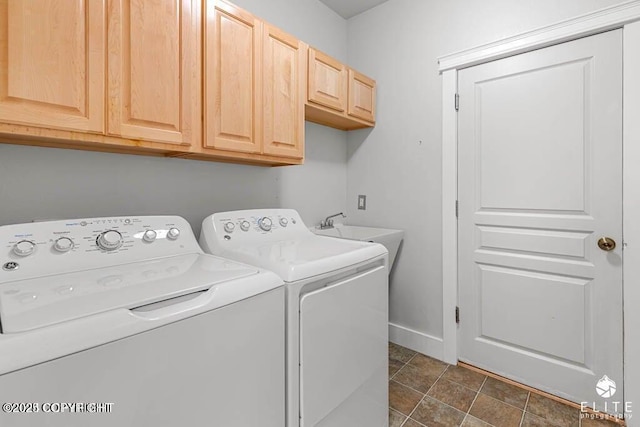 laundry room featuring independent washer and dryer, sink, and cabinets