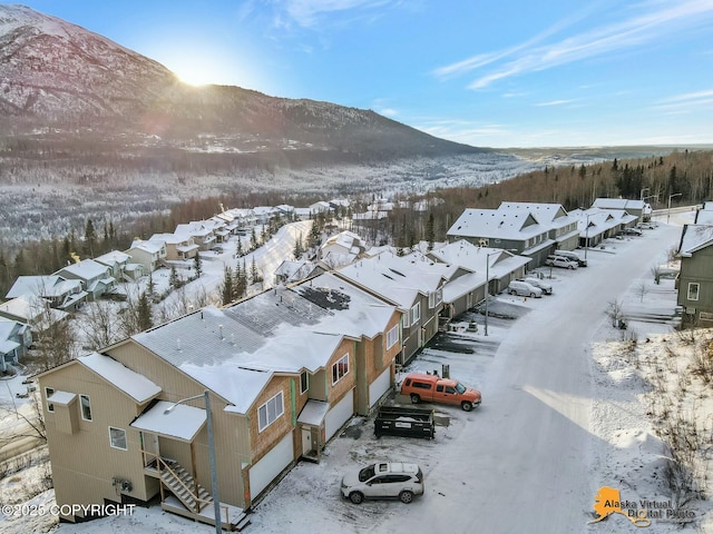 snowy aerial view featuring a mountain view