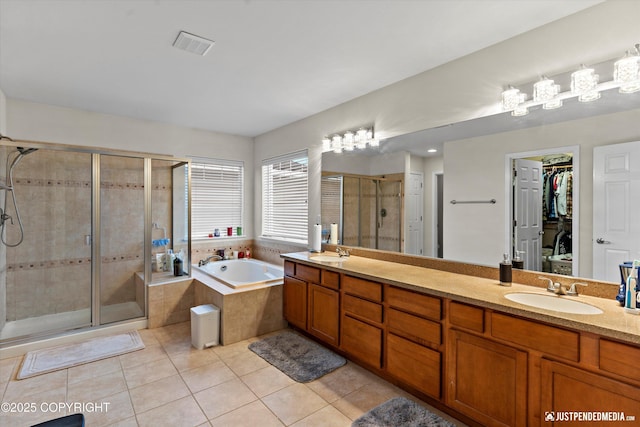 bathroom featuring vanity, tile patterned floors, and plus walk in shower