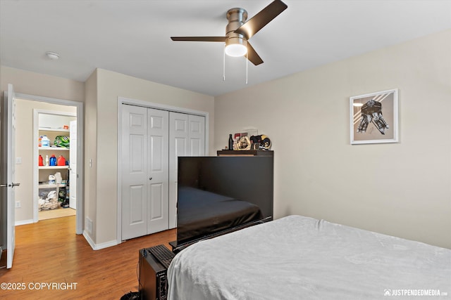 bedroom featuring wood-type flooring, a closet, and ceiling fan