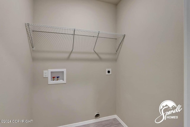 laundry area featuring hookup for a washing machine, electric dryer hookup, and hardwood / wood-style flooring