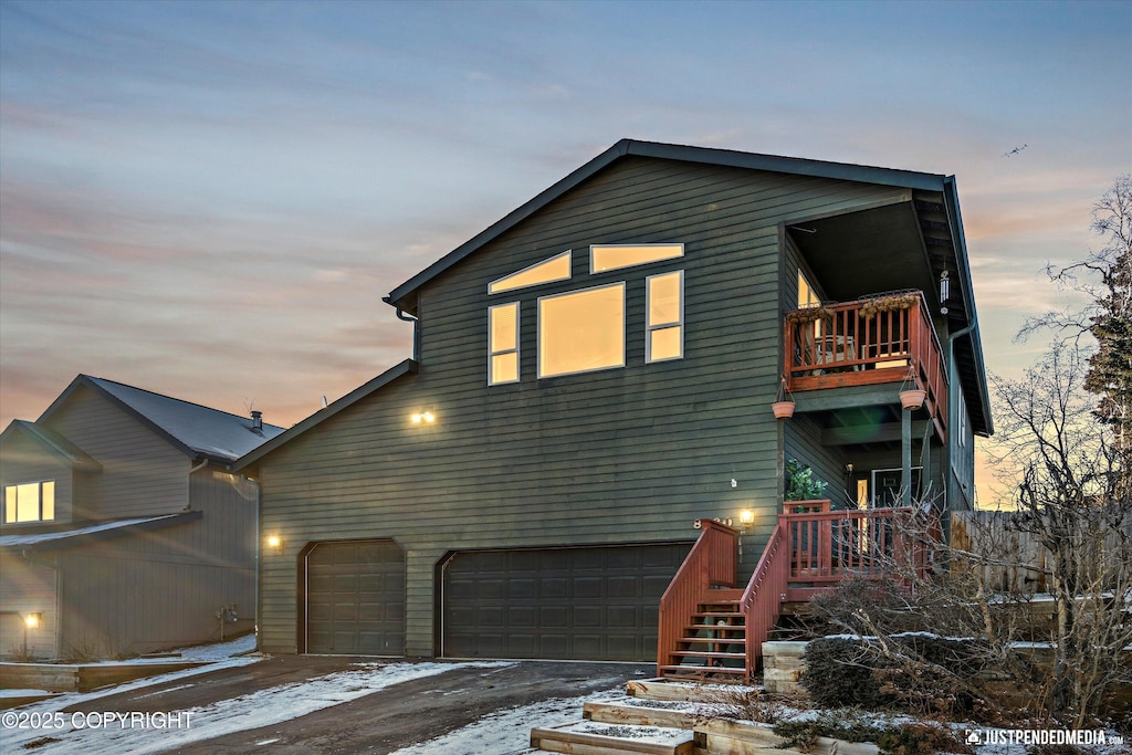 view of front of property featuring a garage and a balcony