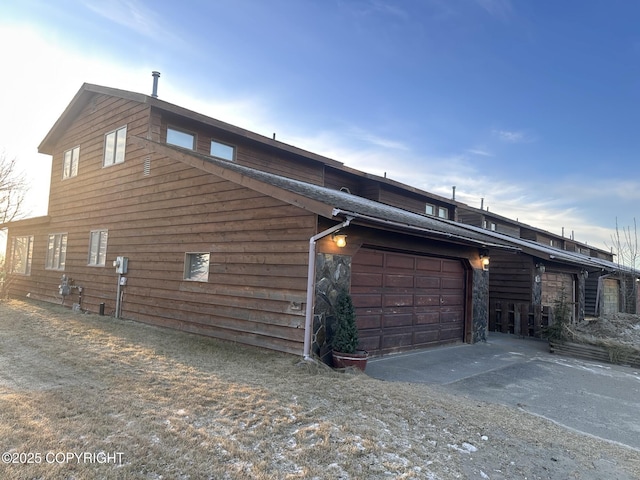 view of side of home featuring a garage